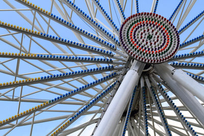 Low angle view of ferris wheel against clear blue sky