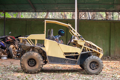 A yellow buggy is parked.