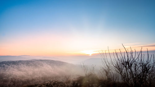 Scenic view of silhouette landscape against sky during sunset