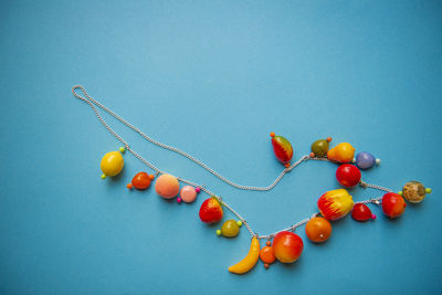 Close-up of cherries on table against blue background