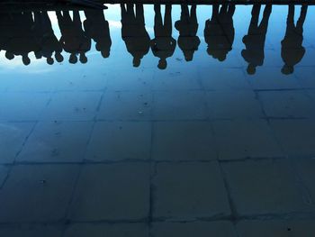 Reflection of people in puddle