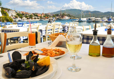 Food on table at restaurant by sea against sky