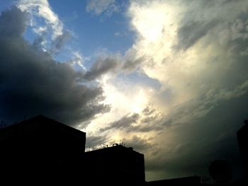 Low angle view of building against cloudy sky