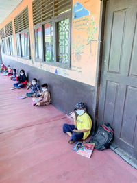 People sitting outside building