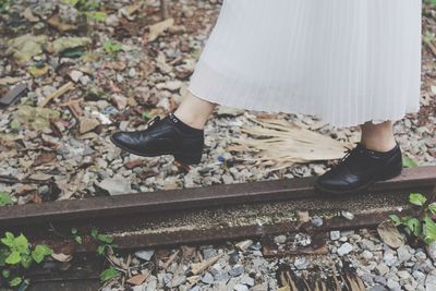 Low section off woman walking on railroad track