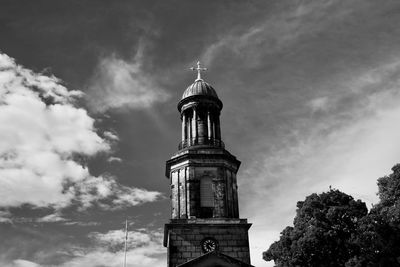 Low angle view of building against cloudy sky