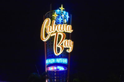 Low angle view of illuminated sign at night