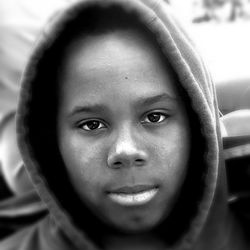 Close-up portrait of man in hooded shirt