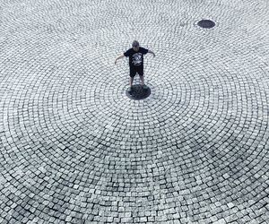 High angle view of man standing on footpath