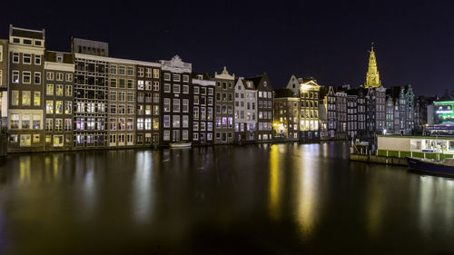 Reflection of buildings in city at night