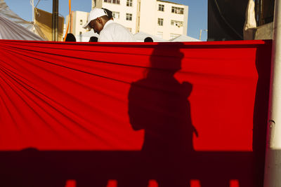 Shadow of people on red wall