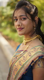 Portrait of smiling woman standing outdoors