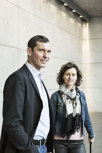 Portrait of confident business people standing at railroad station