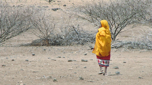 Rear view of a boy walking in winter