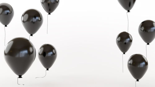 Low angle view of balloons against white background