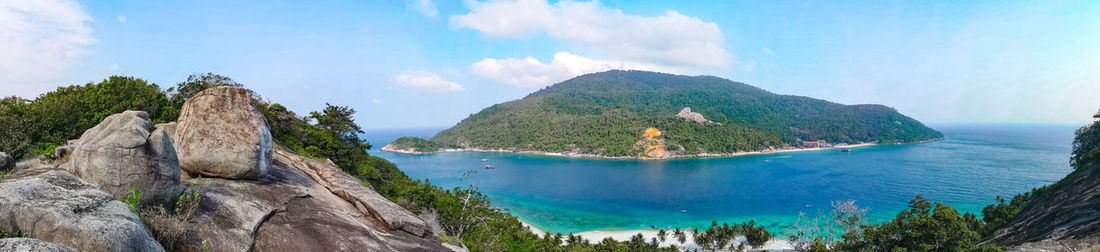 Panoramic view of sea and mountains against sky