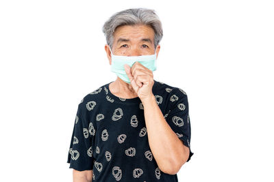 Portrait of man standing against white background