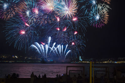 Firework display in city at night