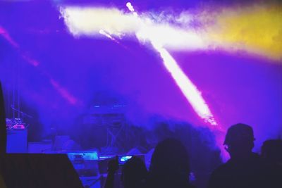 People enjoying music concert at night