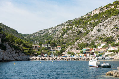 Scenic view of sea by buildings against sky