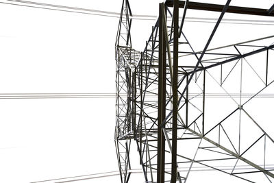 Low angle view of electricity pylon against clear sky