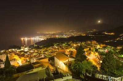 High angle view of illuminated buildings in city at night