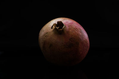 Close-up of apple against black background