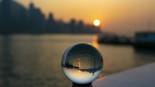 Crystal ball reflect the urban skyline of hong kong with sunset