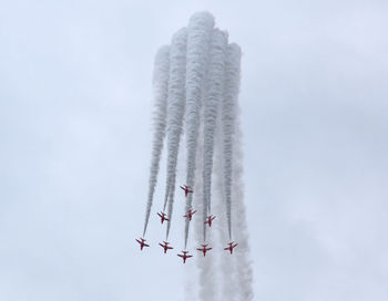 Low angle view of airplane flying against sky