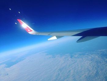 Cropped image of airplane flying over landscape