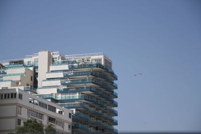 Low angle view of buildings against blue sky
