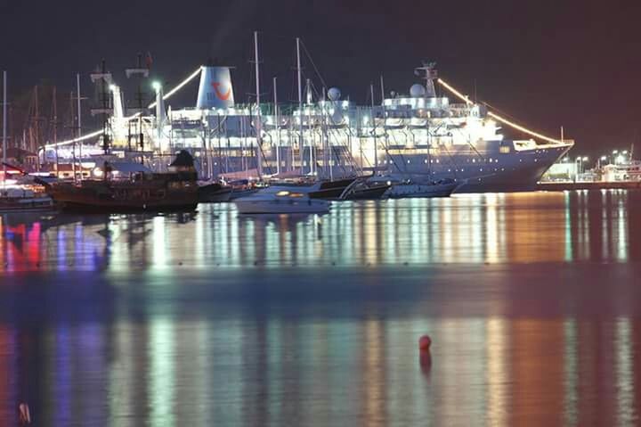 nautical vessel, water, boat, moored, transportation, waterfront, mode of transport, reflection, harbor, sea, mast, sailboat, night, lake, commercial dock, illuminated, river, sky, outdoors, no people