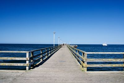 Wooden pier of ahlbeck with incoming ship