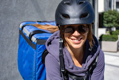 Portrait delivery person riding bicycle in the city