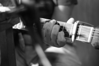 Close-up of man playing guitar