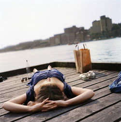 Woman lying on jetty