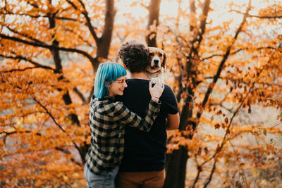 Man standing by tree during autumn