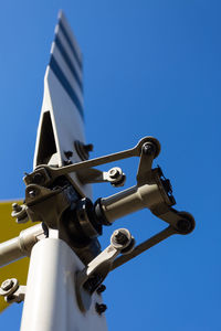 Low angle view of tilt-rotor against clear blue sky