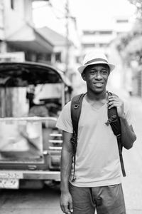 Portrait of man wearing hat standing on street