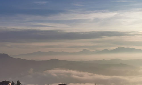 Low angle view of mountains against sky during sunset