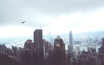 Skyscrapers against cloudy sky