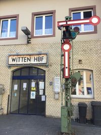 Information sign on street against building