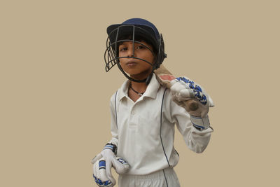 Portrait of boy standing against white background