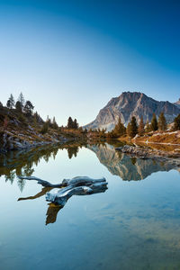 Reflection of mountains in lake against blue sky