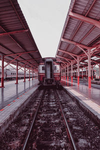 View of train on railroad station platform against sky