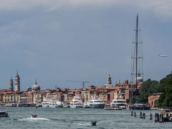 Sailboats in city at waterfront