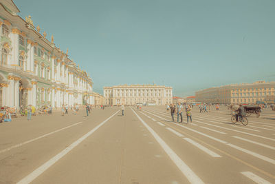 Group of people on road against buildings