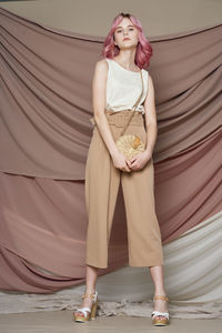 Full length portrait of a smiling young woman