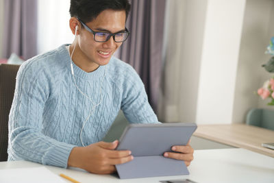 Mid adult man using mobile phone