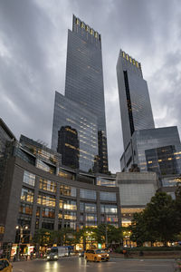 Low angle view of skyscrapers against sky at night